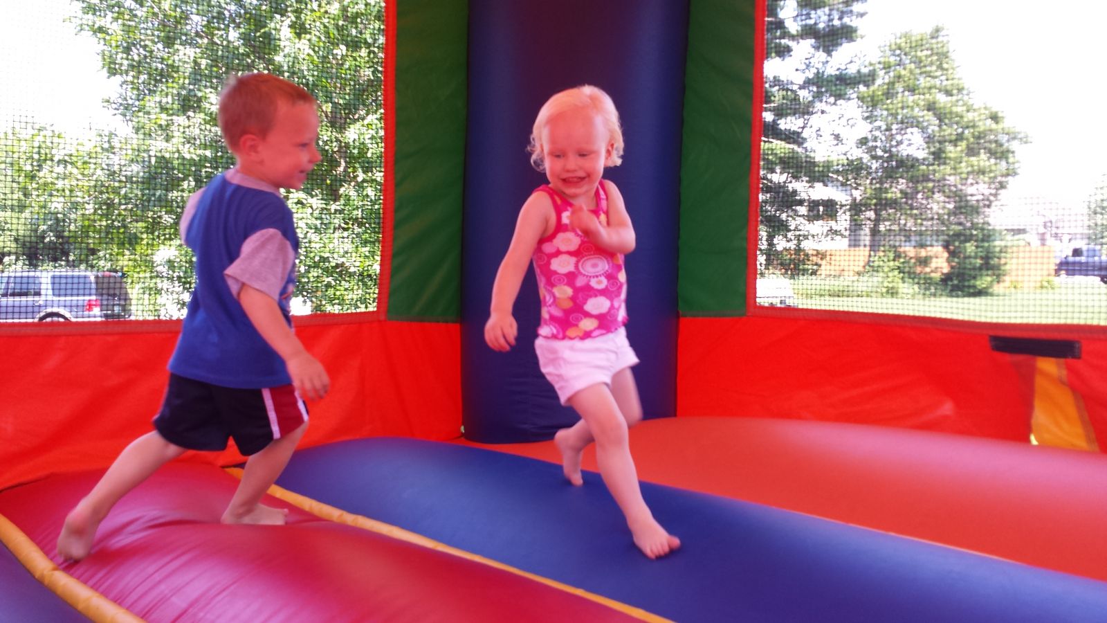 2 Children Playing in Sports Bounce House